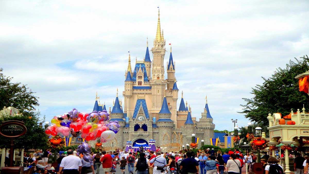 crowd of people and balloons in front of cinderella's castle at walt disney world magic kingdom in Orlando, Florida, USA