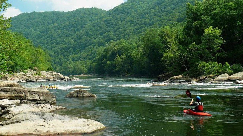 person kayaking down river near pigeon forge tennessee