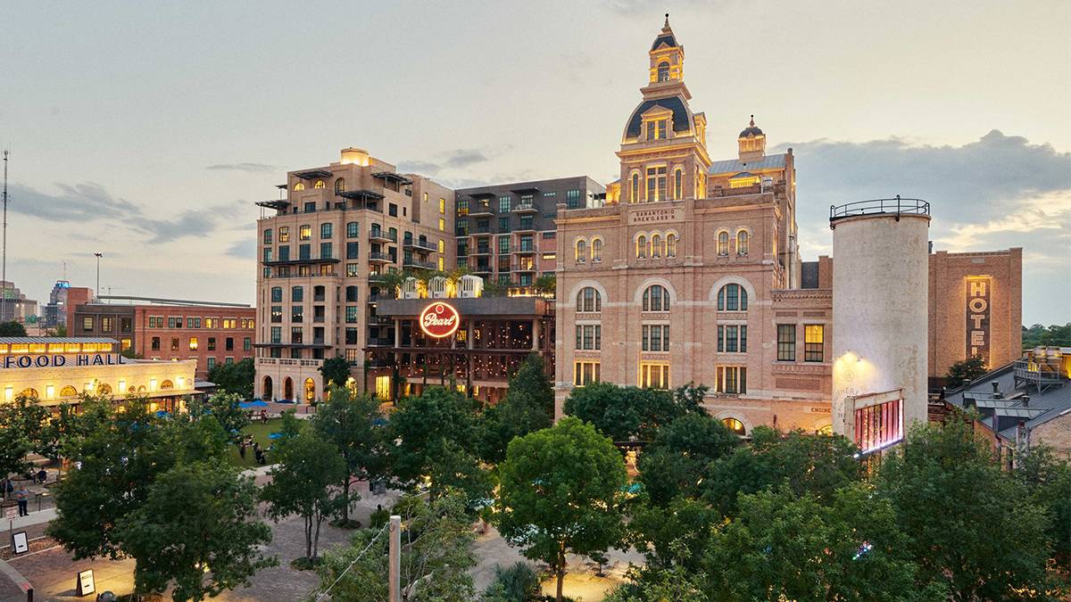 Exterior view of Pearl Brewery at twilight with the light on in San Antonio, Texas, USA