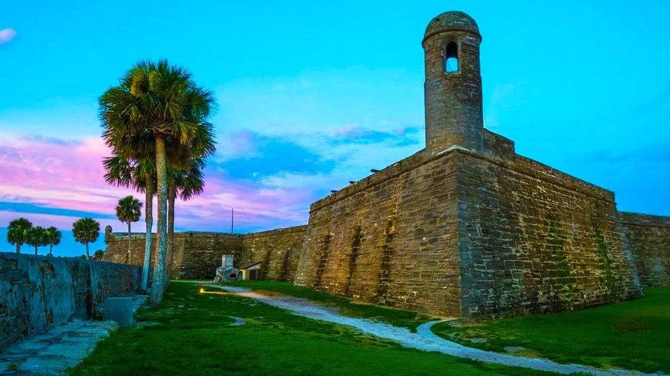 evening view of Castillo de San Marcos National Monument with blue and purple skies