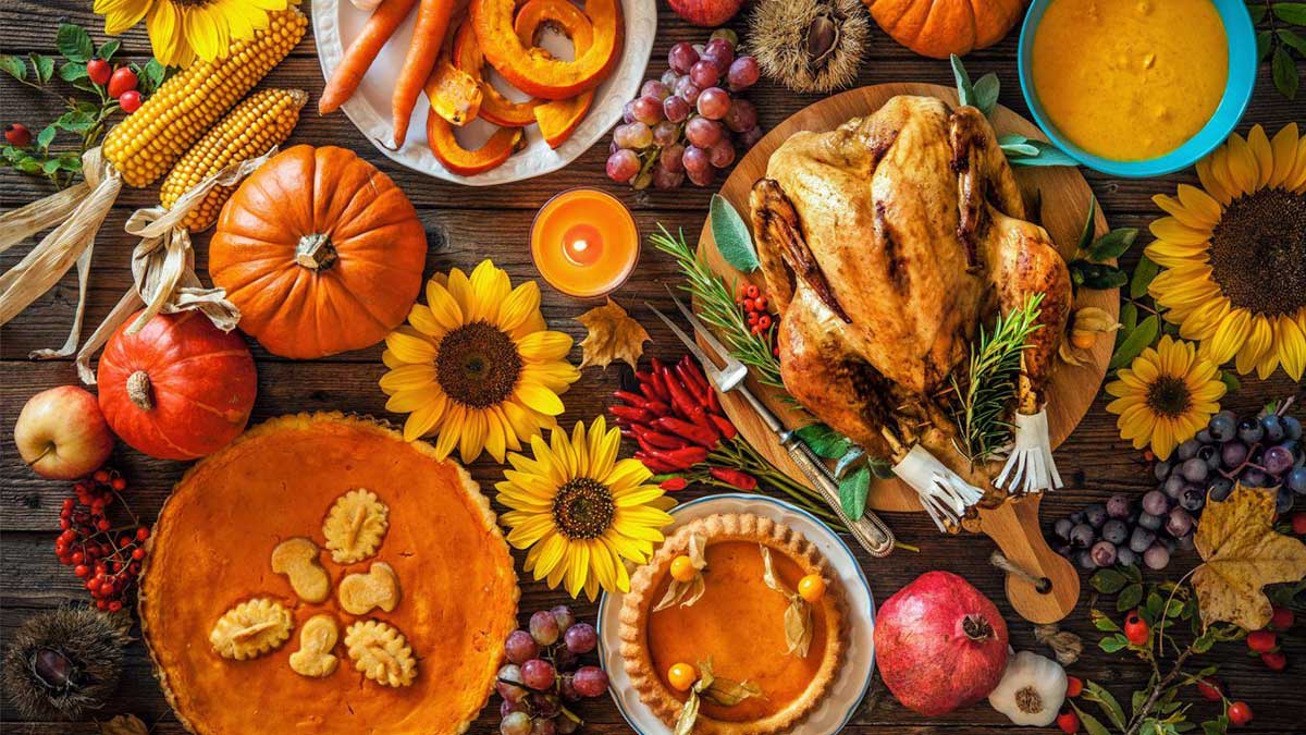 close up of Thanksgiving tablescape with pumpkin pie turkey soup and sunflowers