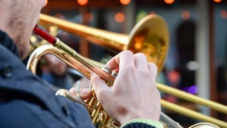 close up of man playing trumpet in a jazz band