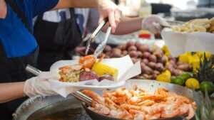 A server dishes seafood at the Little River Shrimp Fest in Myrtle Beach, SC, USA