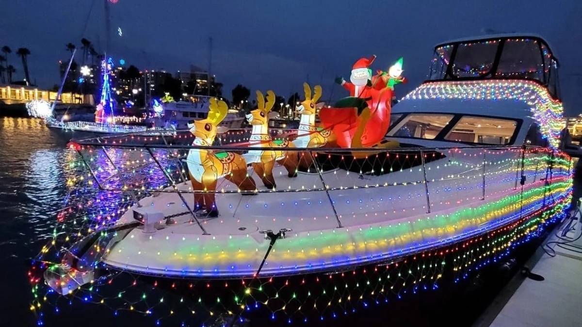 a boat decorated with holiday lights and a Santa Claus display for the Marina Del Rey Boat Parade in Marina Del Rey, CA, USA