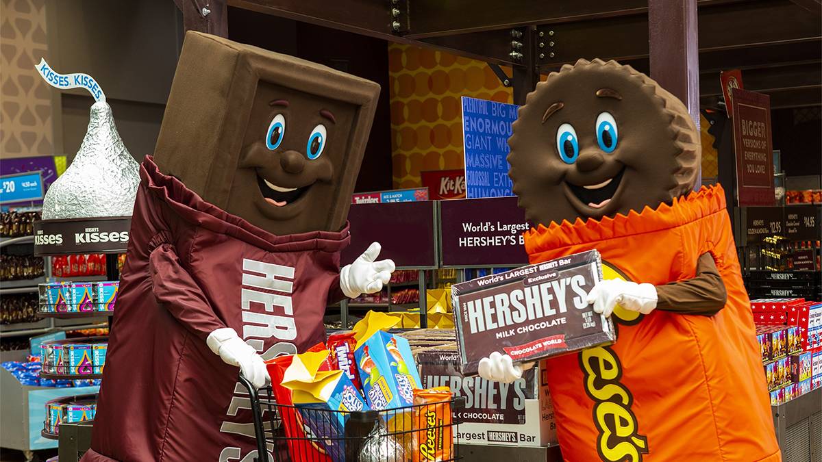 Close up of a Hershey's mascot and a Reeses' Mascot shopping at Hershey's Chocolate World near Harrisburg, Pennsylvania, USA