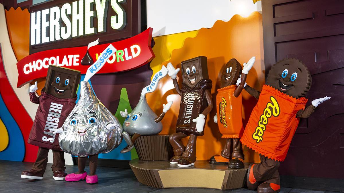 Close up of several different Hershey chocolate mascots standing in front of a sign for Hershey's Chocolate World near Harrisburg, Pennsylvania, USA