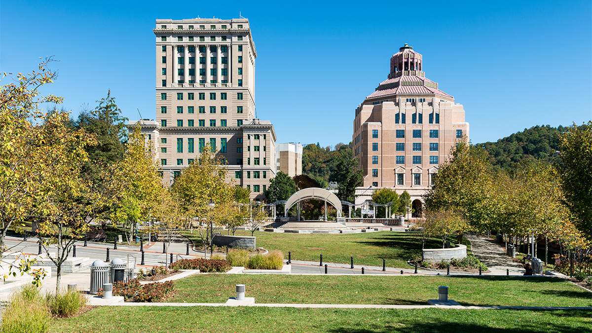 Looking over Pack Square Park on a sunny day with a blue sky and buildings in the background in Asheville, North Carolina, USA