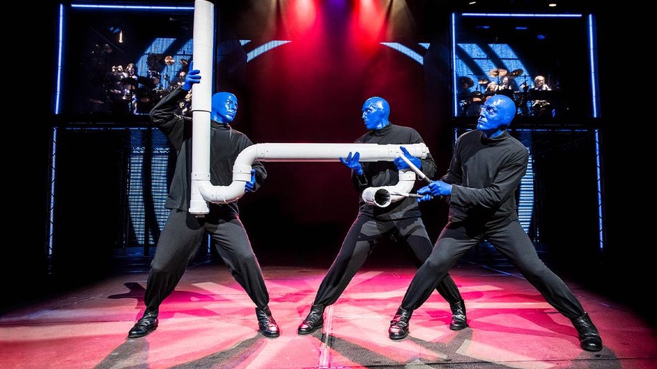Blue Man Group playing a very large pvc pipe instrument at their concert in NYC, New York