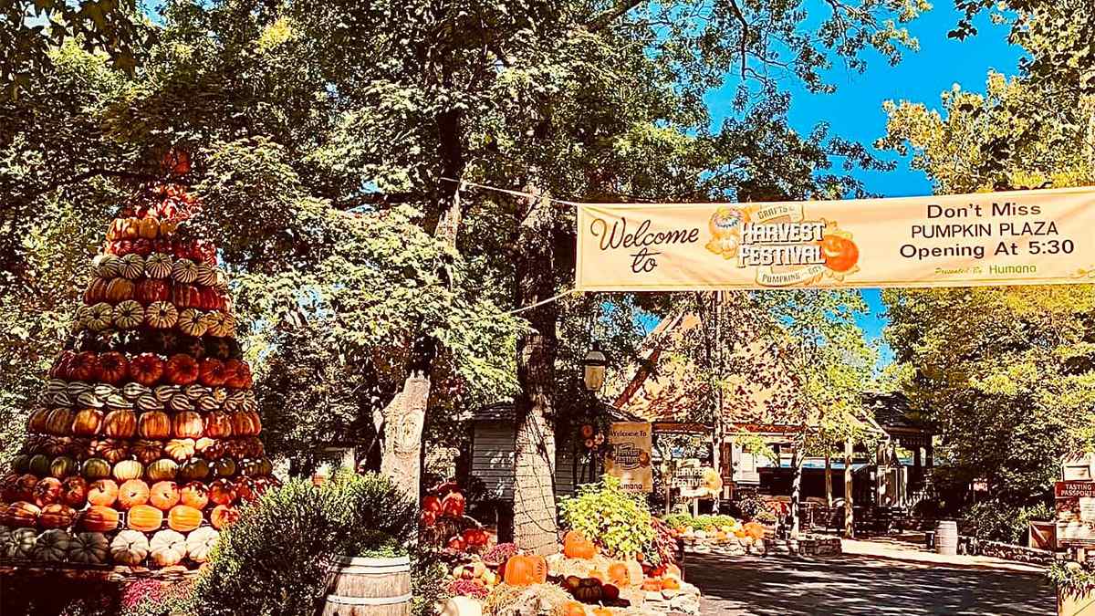 Wide shot of the entrance to the Harvest Festival at Silver Dollar City with a tower of pumpkins on the left side in Branson, Missouri, USA