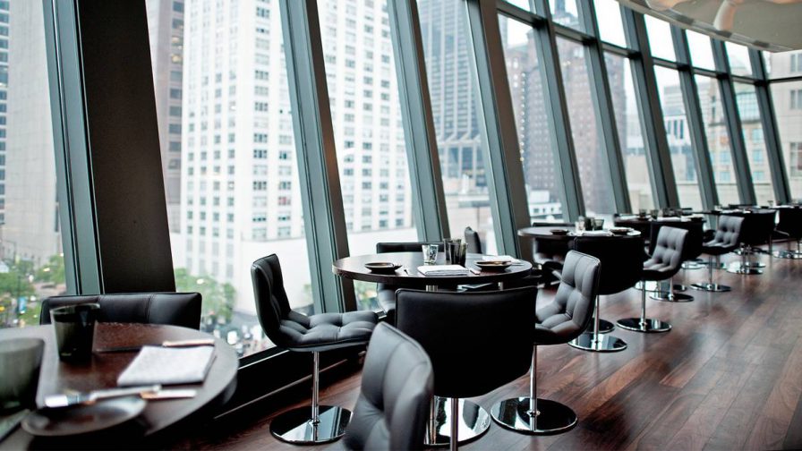 View of the dining area along the windows at NoMi Chicago in Chicago, Illinois, USA