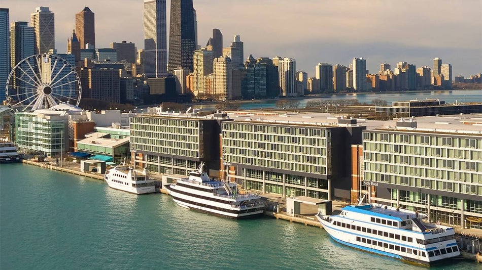 Aerial view of the Sable Hotel on Navy Pier at dusk with boats along side it and the Wheel in the background in Chicago, Illinois, USA