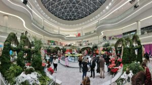 Interior view of the American Dream Mall with lots of people and landscaping on the bottom floor in Rutherford, New Jersey, USA
