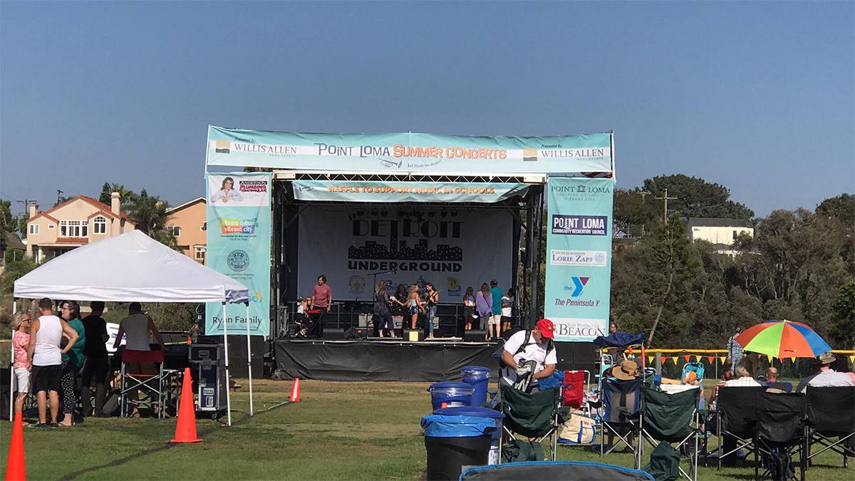 Wide shot of people setting up for Point Loma Summer Concerts in San Diego, California, USA