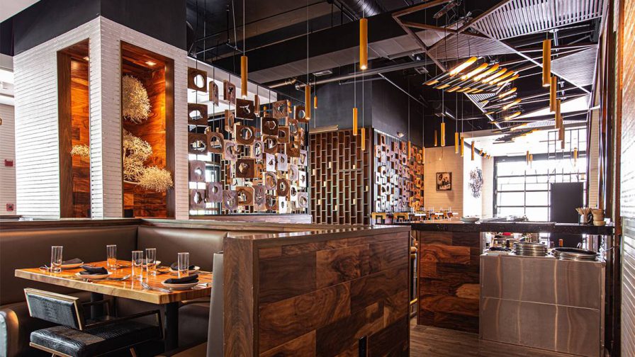 Dining room with lots of wooden decor and tables with leather benches at Chai Yo Modern Thai in Atlanta, Georgia, USA