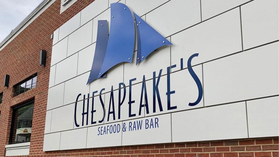 Close up photo of the blue and white sign for Chesapeake’s Seafood and Raw Bar in Gatlinburg, Tennessee, USA