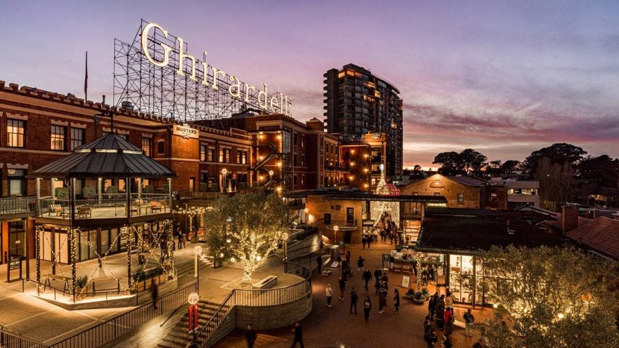 View looking down over Ghirardelli Square with lots of twinkling lights at twilight in San Francisco, California, USA
