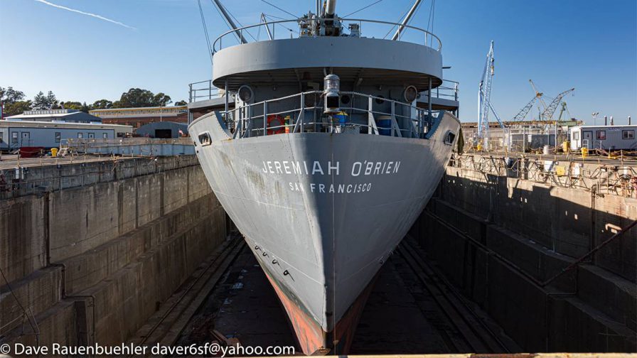 View of the front of the USS Jeremiah O’Brien not on the water with a blue sky behind it in San Francisco, California, USA