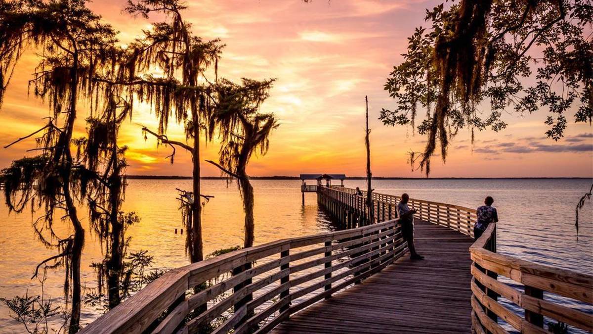 An orange and pink sunset on the pier at Alpine Grove Park in St Augustine, Florida, USA