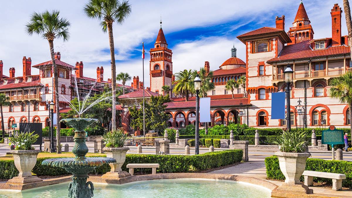 Wide shot of the historic style Spanish buildings with red roofs and a fountain at Guy Harvey Oceanfront Resort St. Augustine Beach in St Augustine, Florida, USA