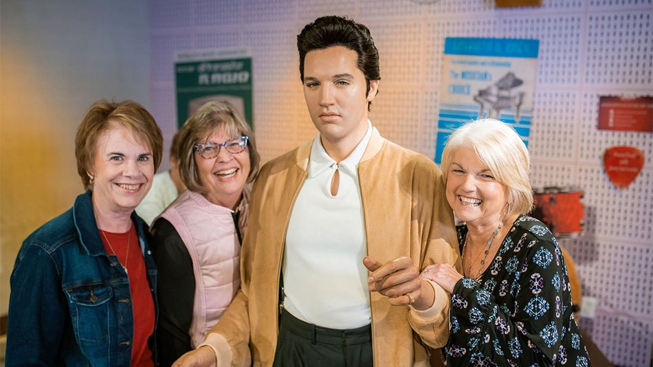 guests posing beside wax figure of Elvis Presley at Madame Tussauds Nashville in Nashville, Tennessee, USA
