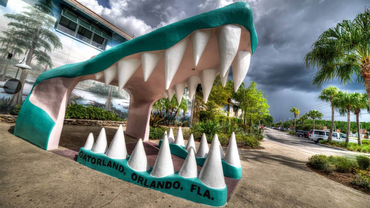 angled shot of entrance to Gatorland with close up of statue of open gator mouth in Orlando, Florida, USA