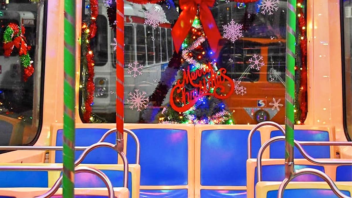vehicle with bright blue seats called Holly Jolly Trolley adorned with christmas themed decorations in Philadelphia, Pennsylvania, USA
