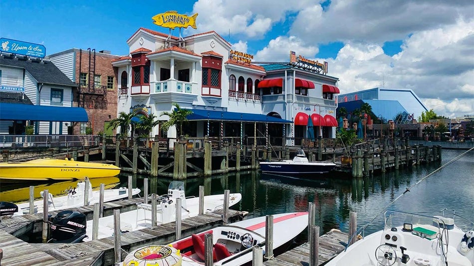 exterior of Lombard's Seafood Grille with view of dock and boats and water at Universal Orlando in Orlando, Florida, USA
