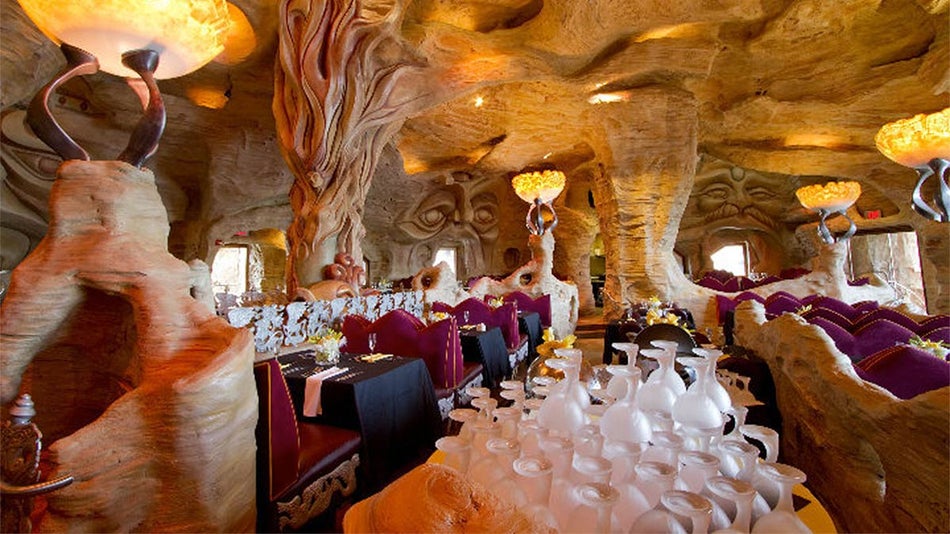 interior of Mythos Restaurant with tables, chairs, and intricate ceiling and walls at Universal Orlando in Orlando, Florida, USA