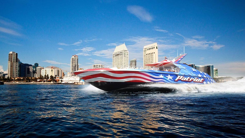Patriot Jet Boat on water with buildings in background on a sunny day in San Diego, California, USA