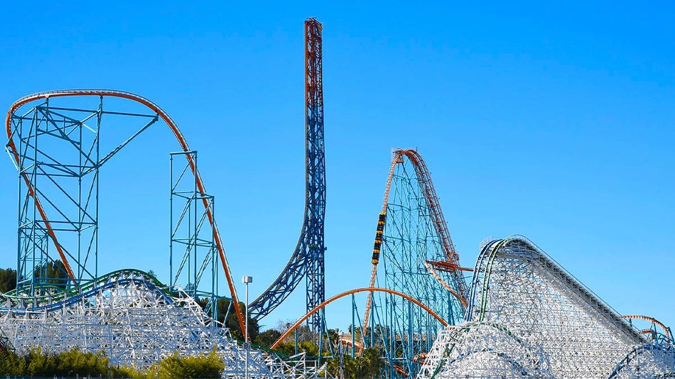 wide shot of rides during sunny day at Six Flags Magic Mountain in Los Angeles, California, USA