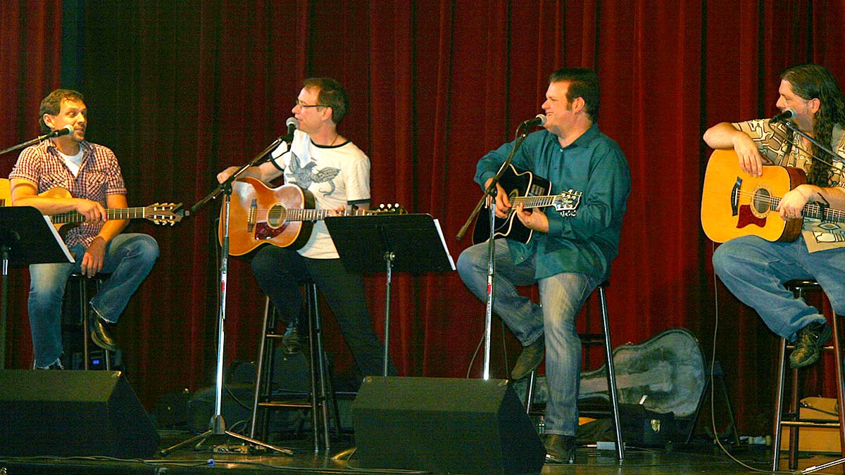 musicians with guitars and microphones performing on stage at The Smoky Mountains Songwriters Festival in Gatlinburg, Tennessee, USA