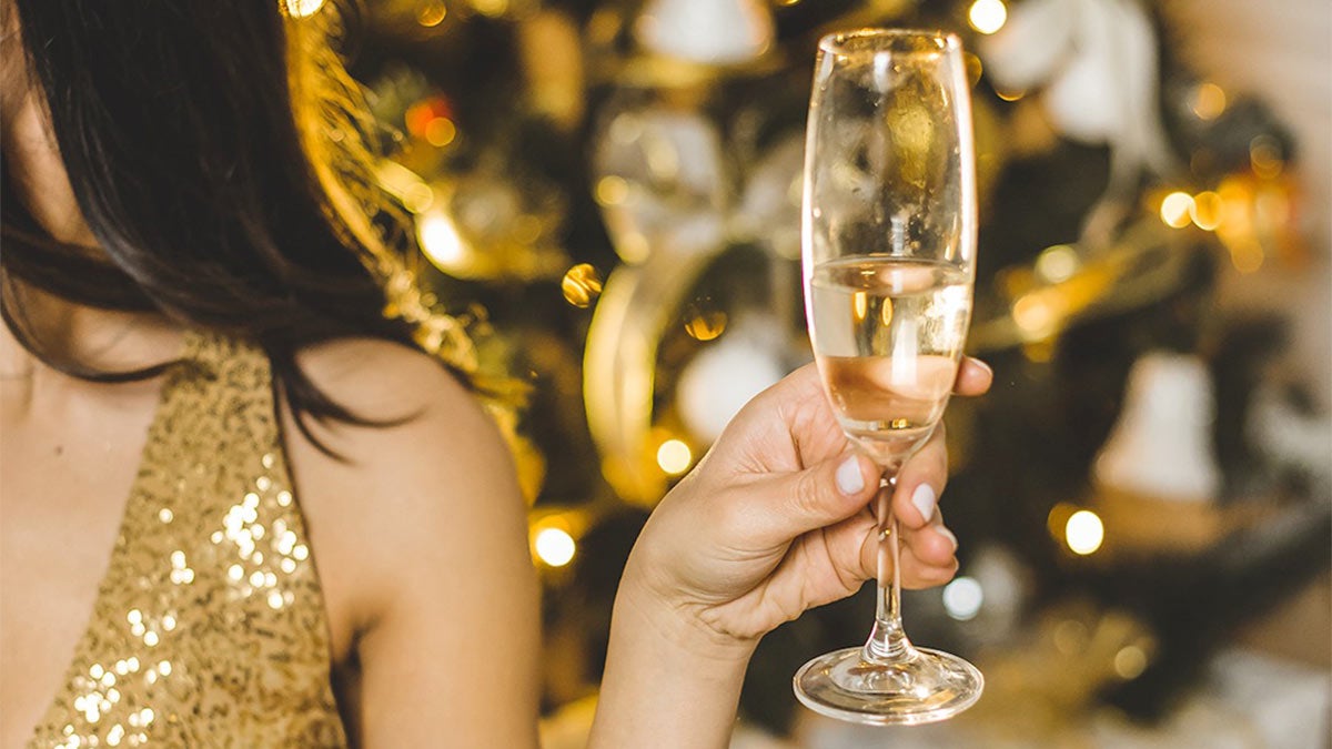 a girl holding a glass of wine