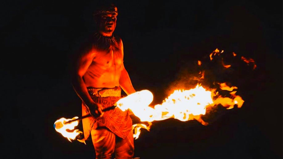 close up of Fire Dancer at night at Paradise Cove Luau in Oahu, Hawaii, USA