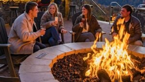 group of friends with drinks seated around Fire Pit at Bear village in Anakeesta,Gatlinburg, Tennesee, USA