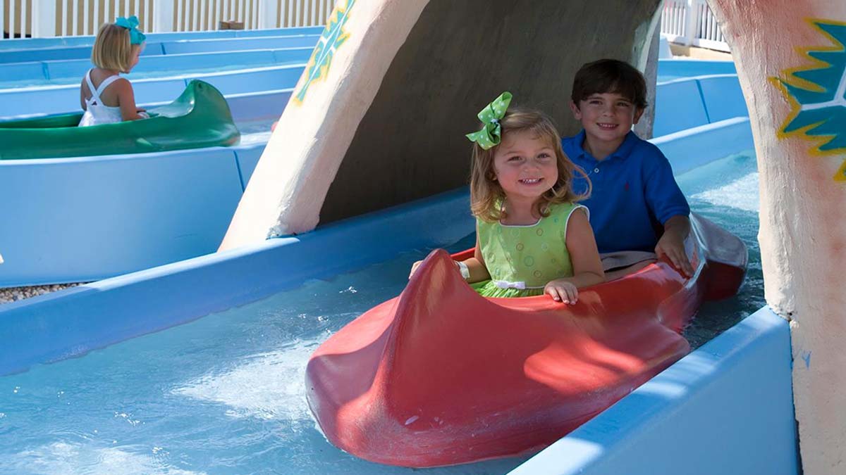smiling children on Free Floating Mini Canoes ride during day at Family Kingdom Park in