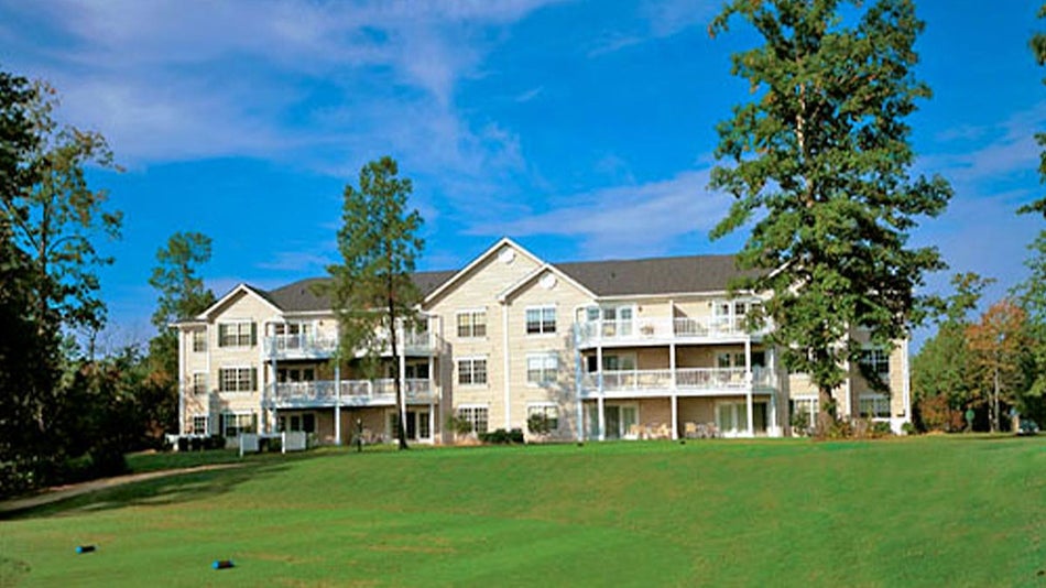 exterior of Greensprings Vacation Resort surrounded by greenery during sunny day in Williamsburg, Virginia, USA