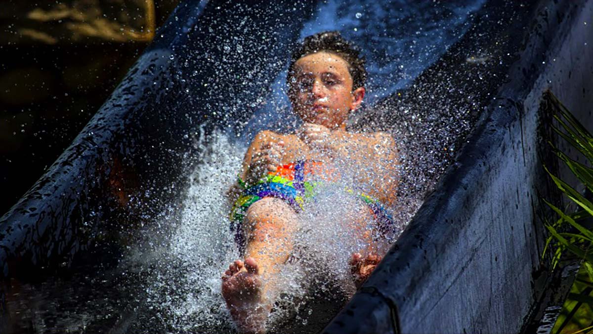 boy sliding down Jumanji Slide at Big Kahuna's in Destin, Florida, USA