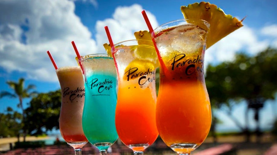 row of colorful drinks like Mai Tai at Paradise Cove Luau in Oahu, Hawaii, USA