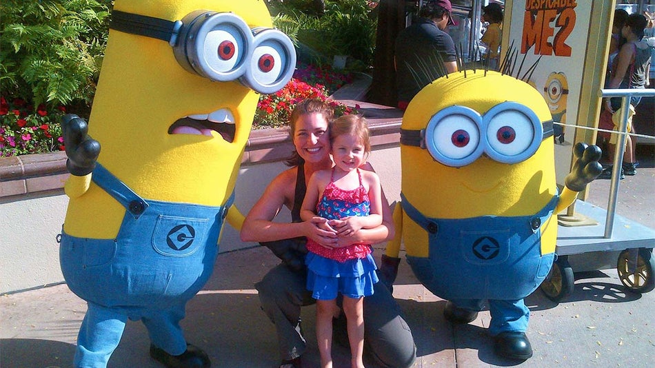 a mother and daughter posing with the Minion characters