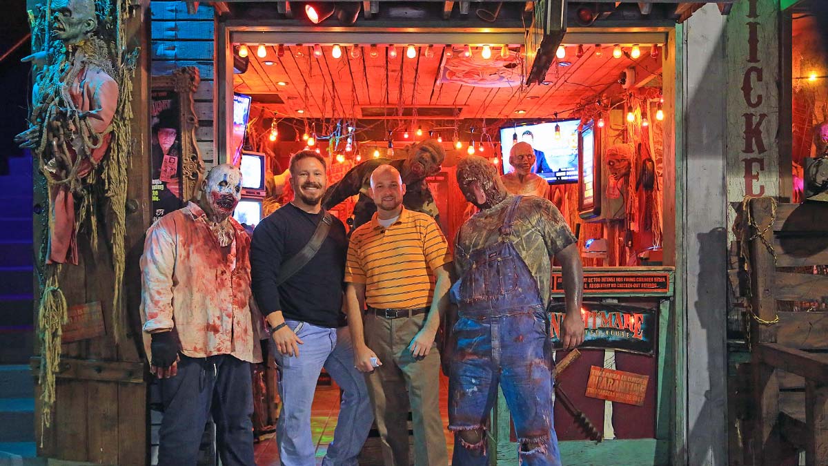 men posing for photo with people in costume at Nightmare Haunted House in Myrtle Beach, South Carolina, USA