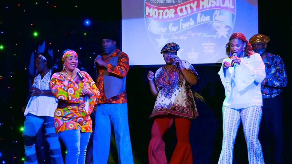 performers on stage dancing in colorful costumes while holding microphones for Motor City Musical at GTS Theatre in Myrtle Beach, South Carolina, USA