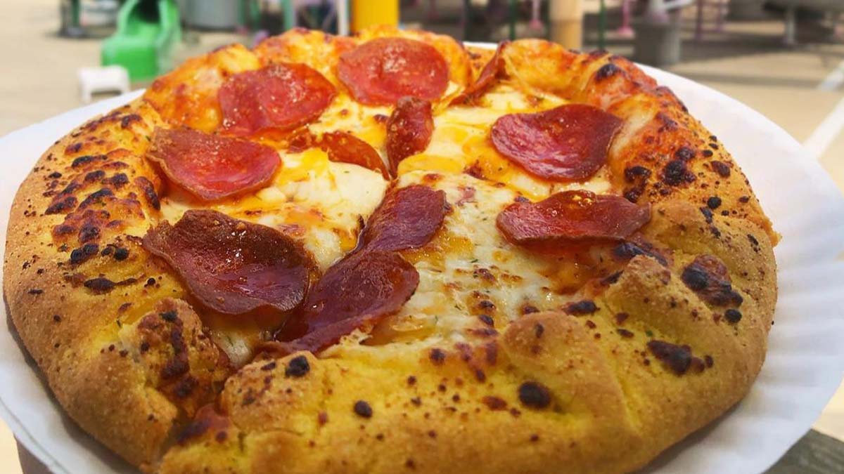 close up of pizza on paper plate topped with pepperoni at Magic Springs in Hot Springs, Arkansas, USA