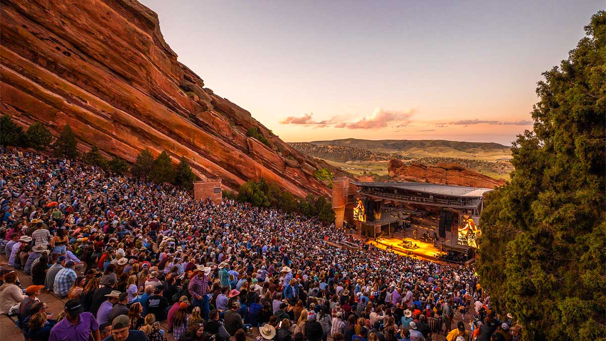 a wide shot of the red rocks and a crowd at the theater 