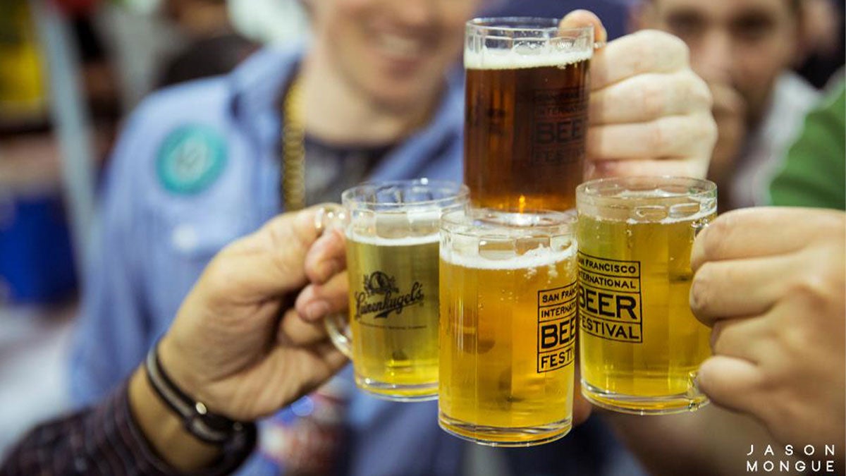 close up of people toasting with beer glasses at San Francisco International Beer Festival in San Francisco, California, USA