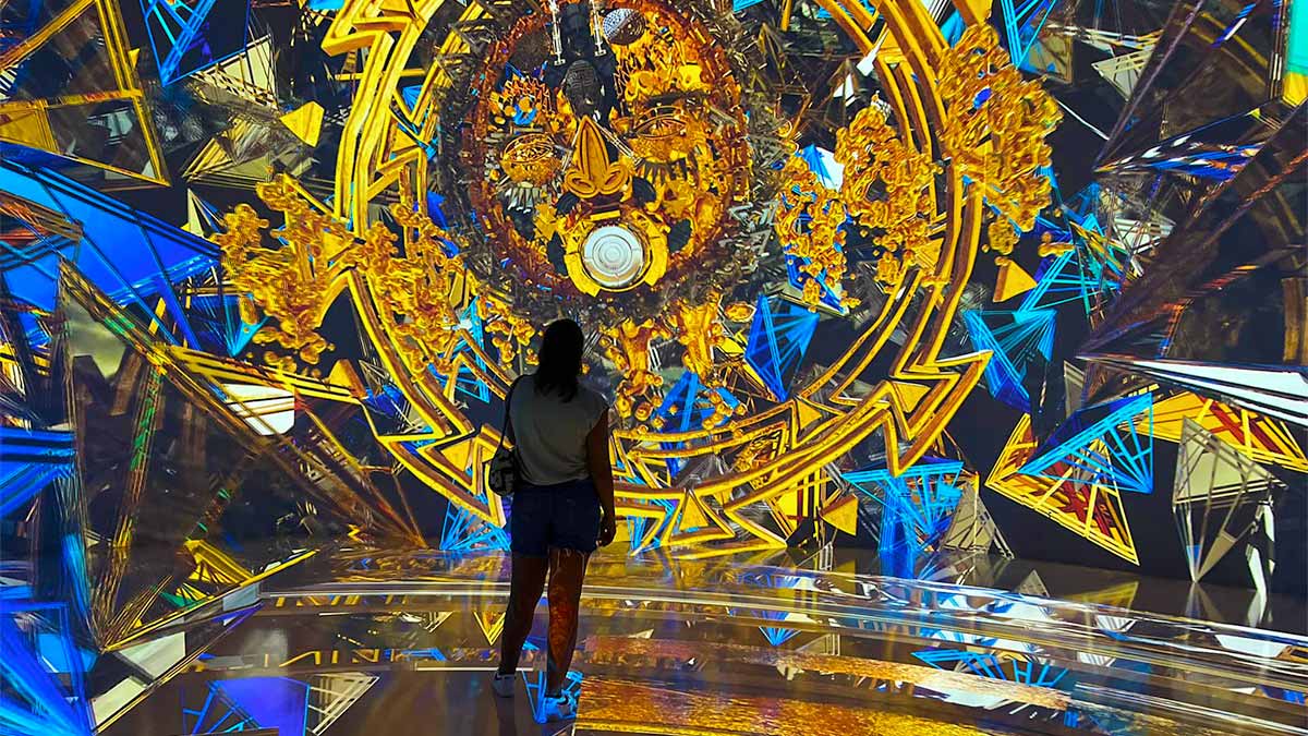 a woman standing in-front of the huge clock at artechouse dc