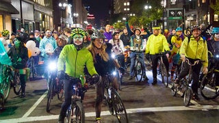 A group photo of bikers taken during Halloween, with people dressed up in various Halloween costumes.