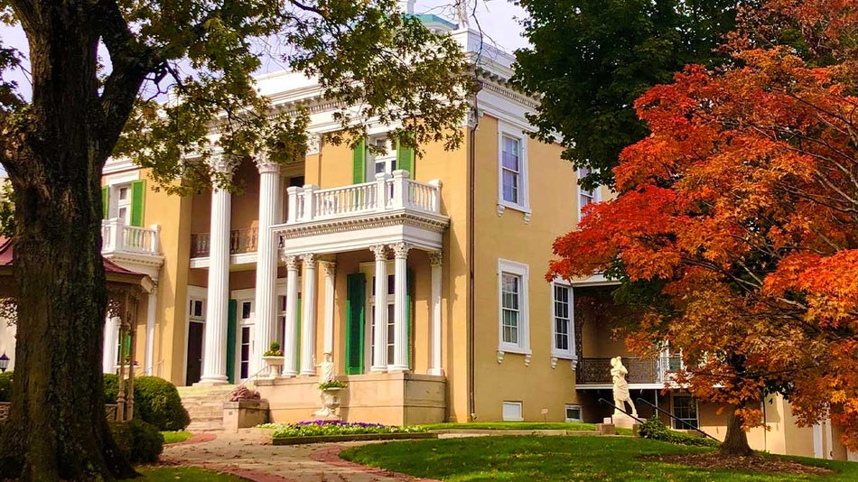 exterior of Fall Belmont Mansion with trees in foreground during fall in Nashville, Tennessee, USA