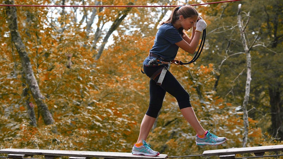 a teen participating in Harnest's Treetop Adventure