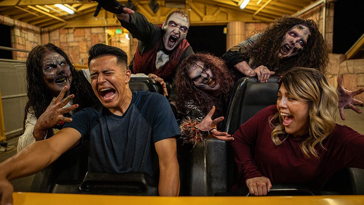 The zombies are chasing the couple in the horror train