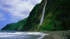 a distance view of a beautiful waterfalls and the ocean